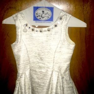 Fancy party dress, lined tulle in skirt.  Sleeveless, faux jewel neckline. Bow